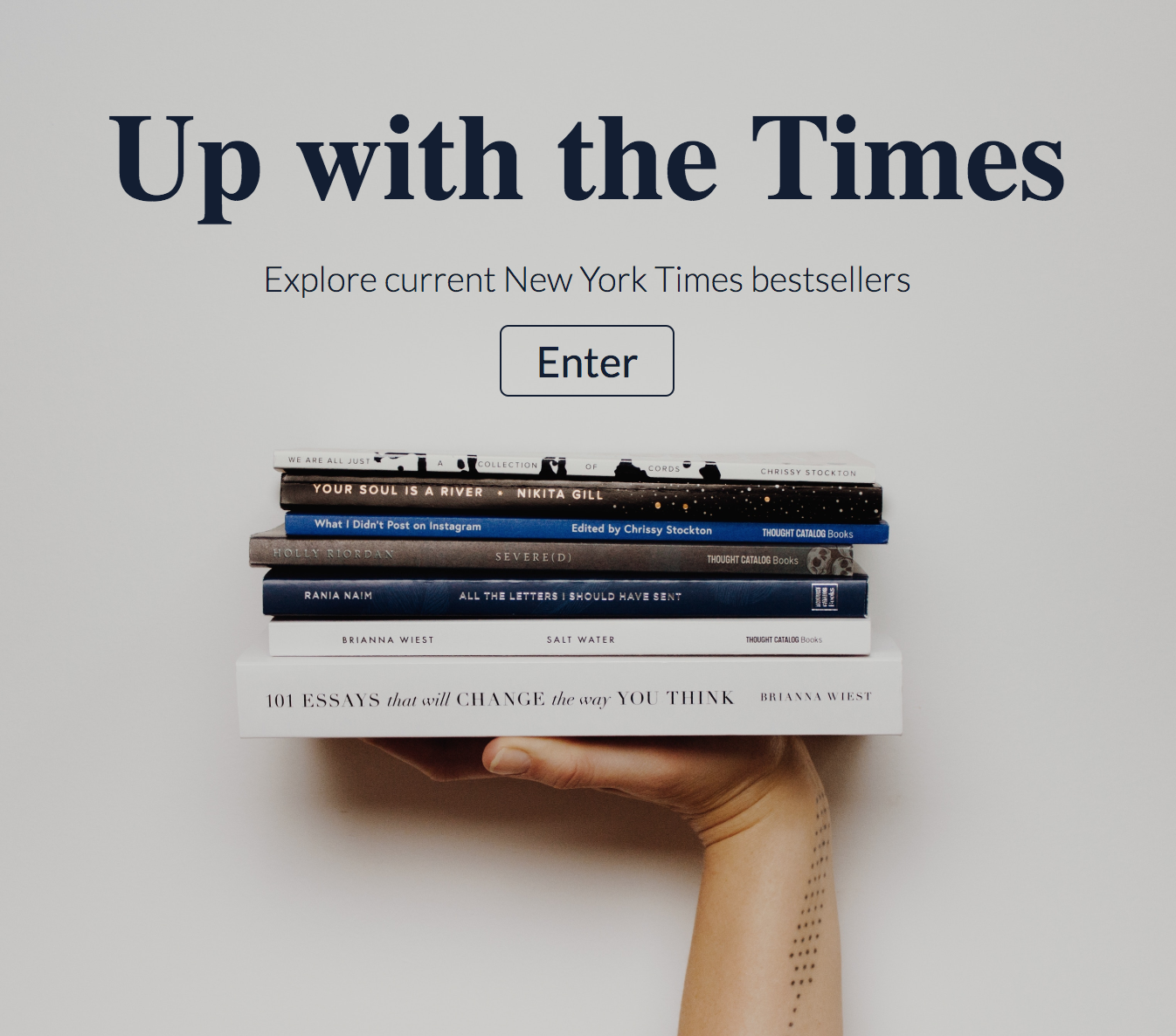 screenshot of up with the times home page, background has a womans hand holding up a pile of books with an enter button.